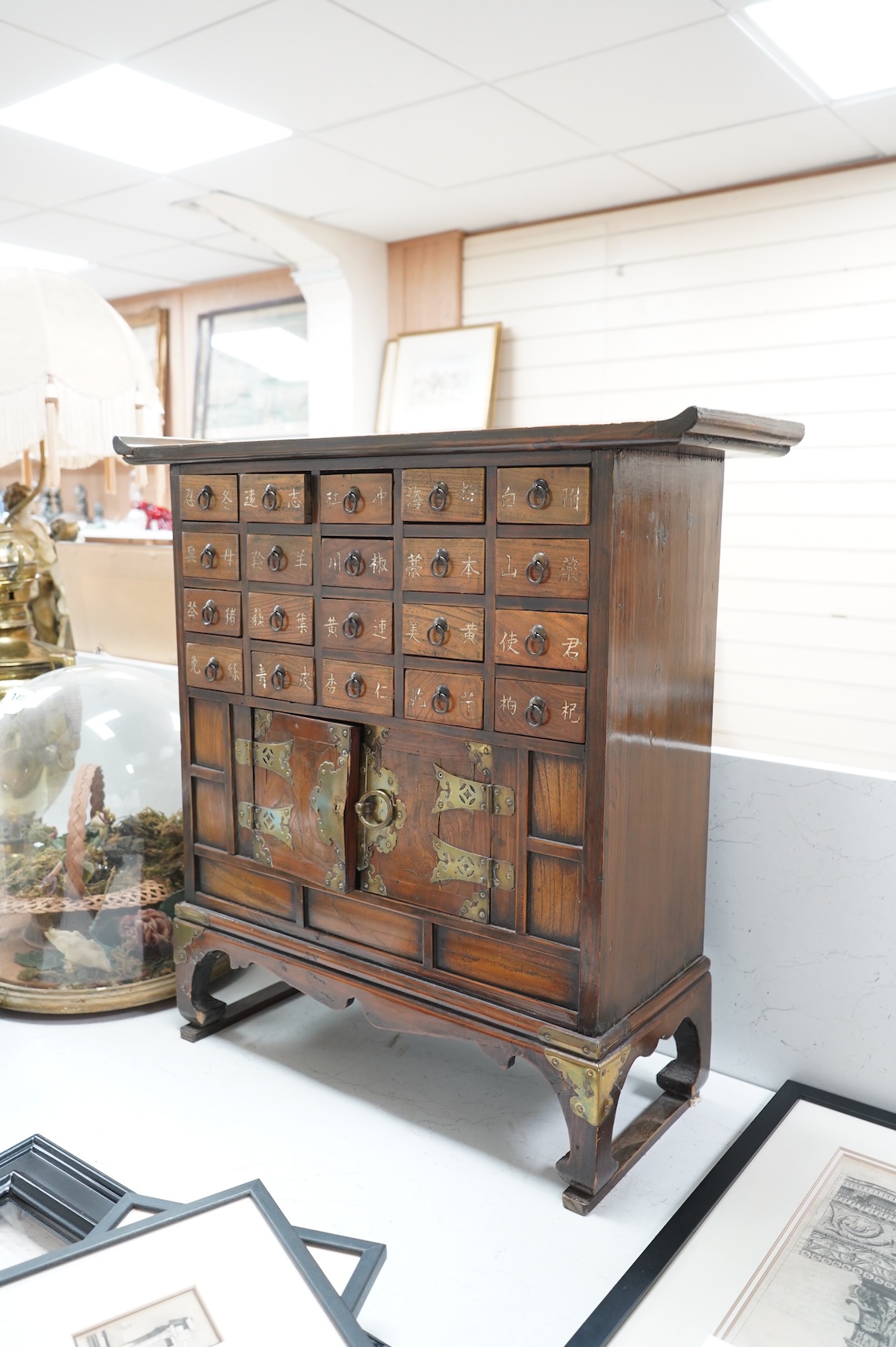 A Korean brass mounted chest with fitted drawers, decorated with calligraphy, 64cm high